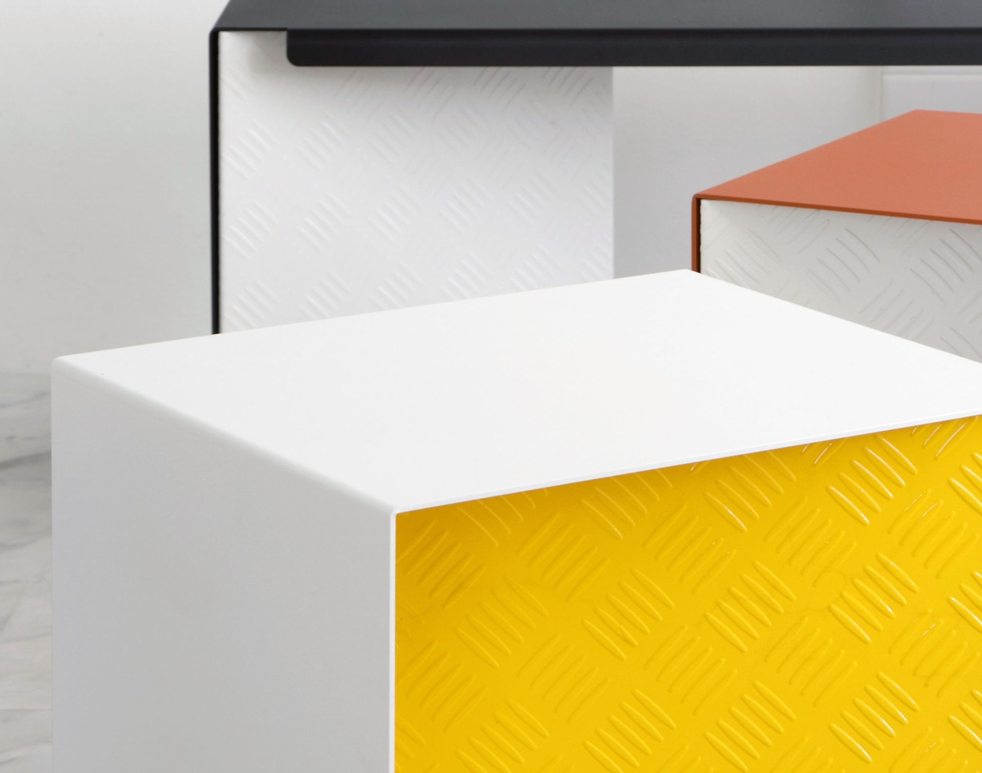 Close detail of Metro's white and yellow checker-plate stool