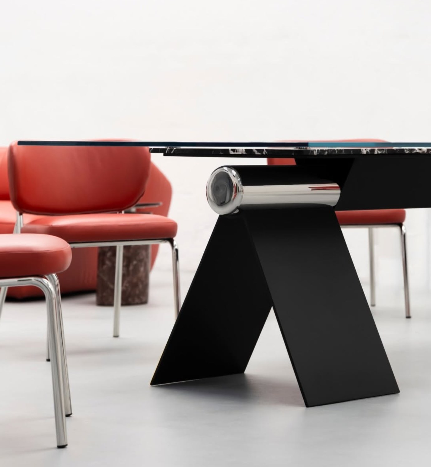 Close view of the HINGE table's exposed joint and folded steel base